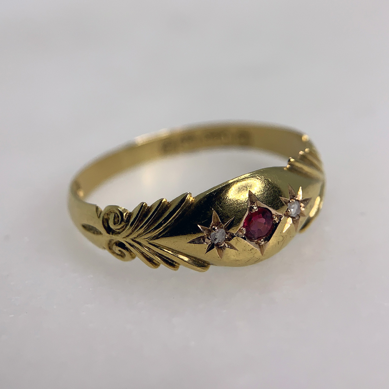 Victorian Diamond and Ruby 15 Carat Gold ornate dress band. The ring holds a deep pink ruby and two glistening diamonds all in star setting.
