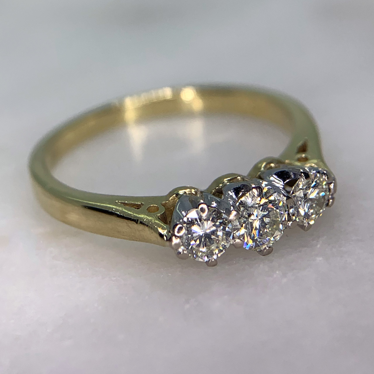 Stunning 0.50 carat Diamond Trilogy Ring in 18ct Hallmarked yellow gold, London. The ring is decorated 0.50 carats of total diamond weight (marked in the shank).  All stones are claw set in platinum with a tiffany 18ct yellow gold polished shank. This ring is in exquisite condition.
