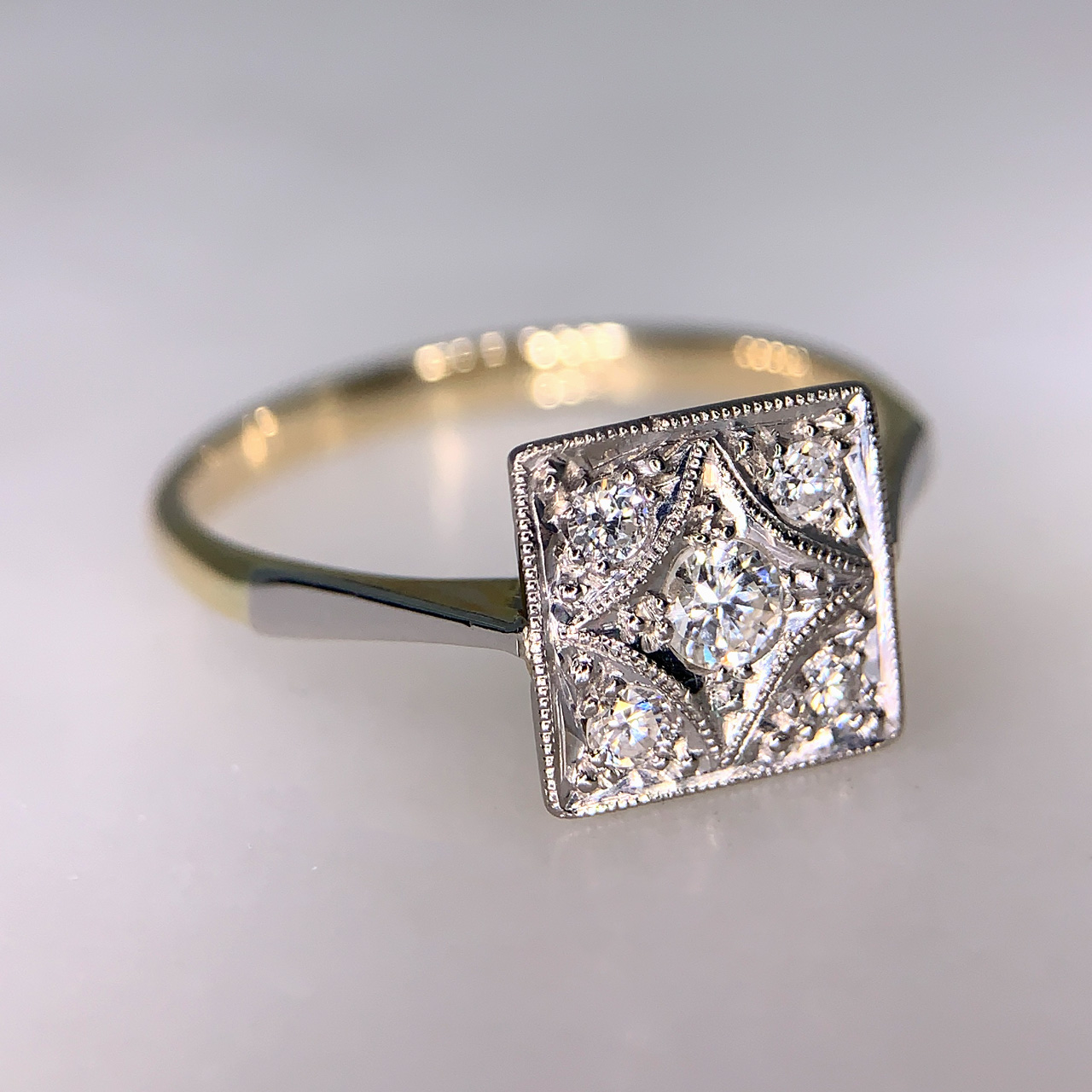 Square Plaque Diamond Platinum and Gold Deco Ring, stamped 18ct in a yellow gold shank. 5 Platinum set diamonds, with platinum shoulders.