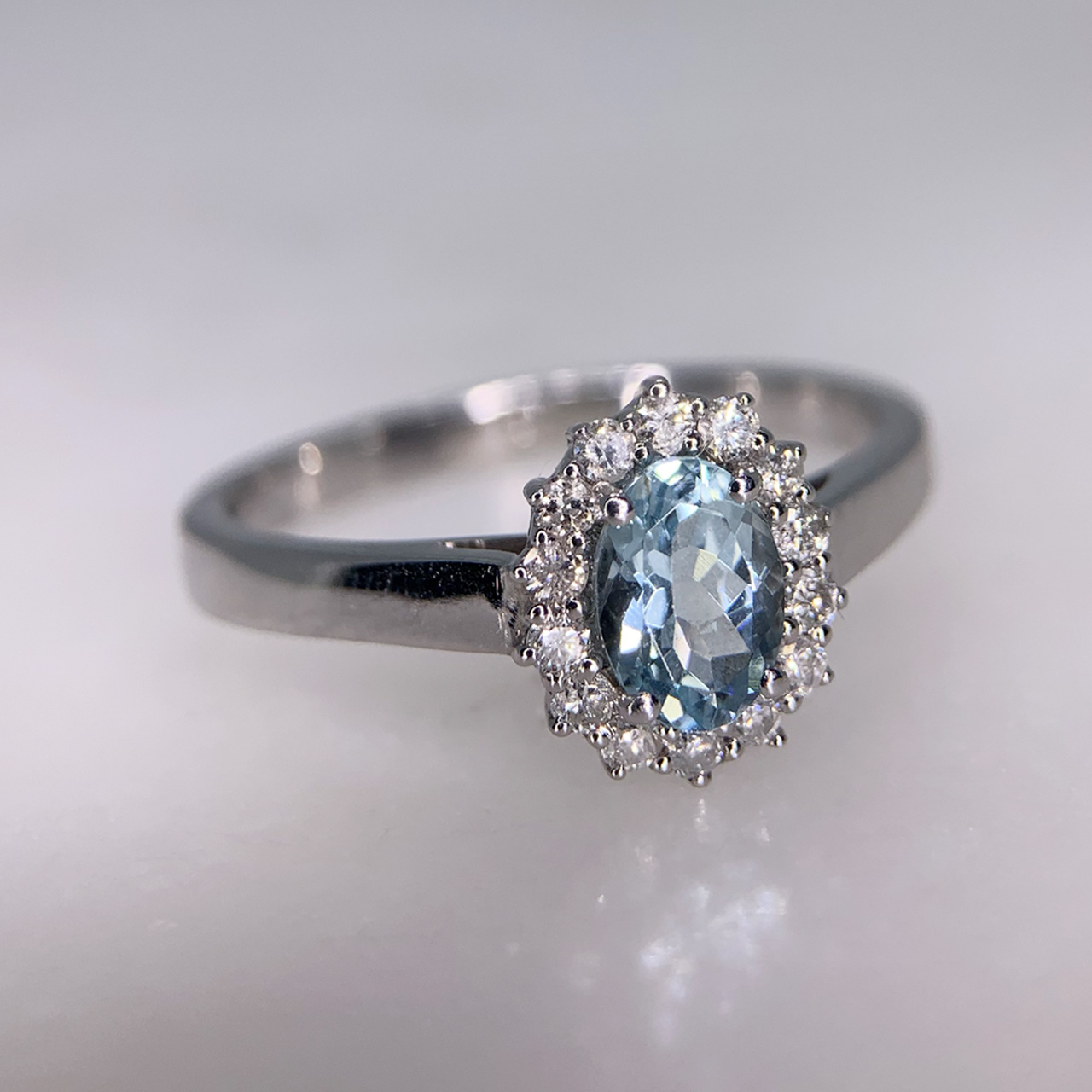 Diamond and Aquamarine White Gold Cluster, Hallmarked 9ct, London. Central Aquamarine, 6.8mm X 4.9mm surrounded by 14 brilliant cut diamonds.