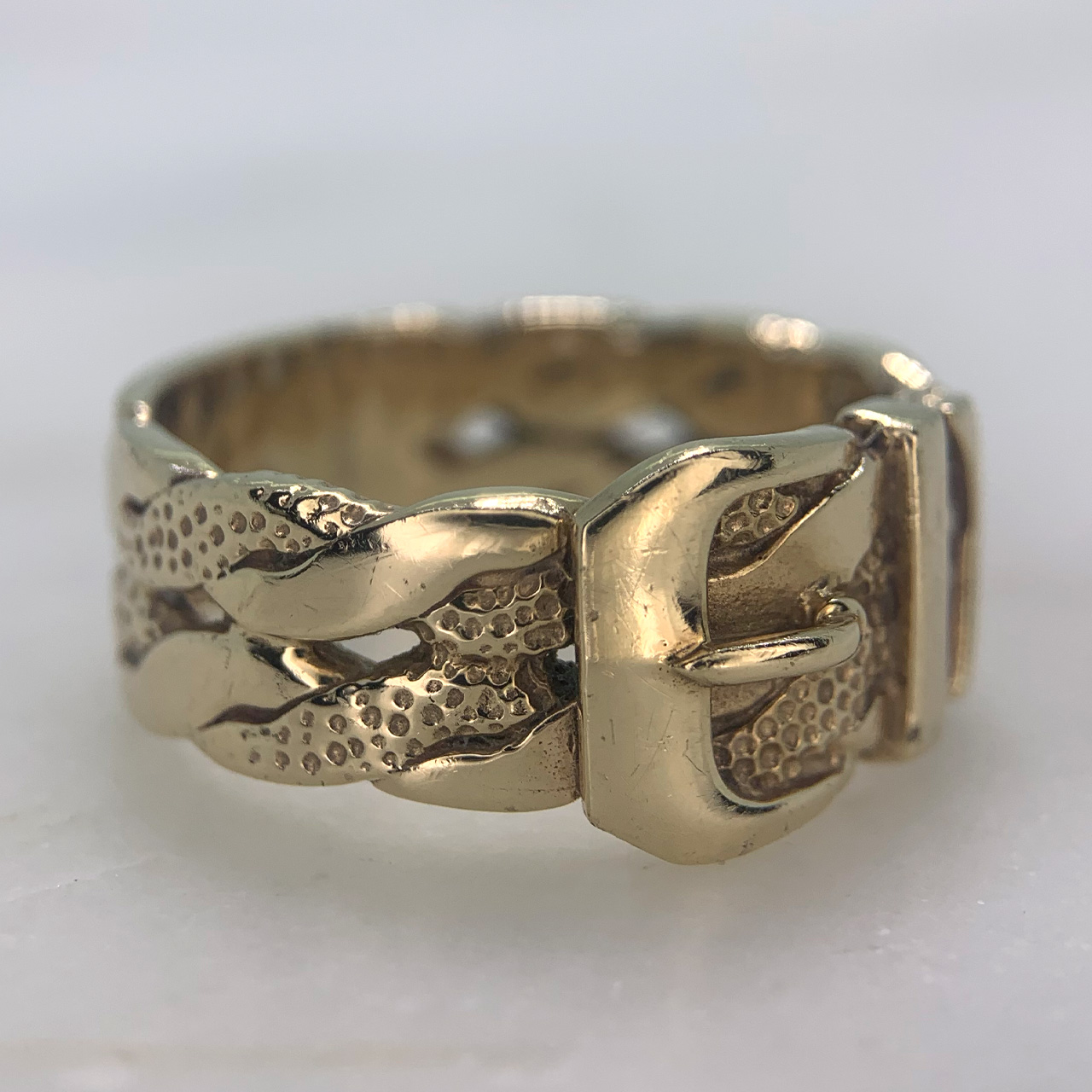 Perfect Rope Twist Buckle Ring in 9ct yellow gold. The Buckle is decorated with a twisted rope design and texture detailing. The solid gold buckle ring is heavy in weight and has a width of 8 mm. The back of the shank is polished to allow for alterations in size, some small colour variations and the removal of original hallmark by previous sizing not completed by our jewellers. An excellent ring in good condition. 